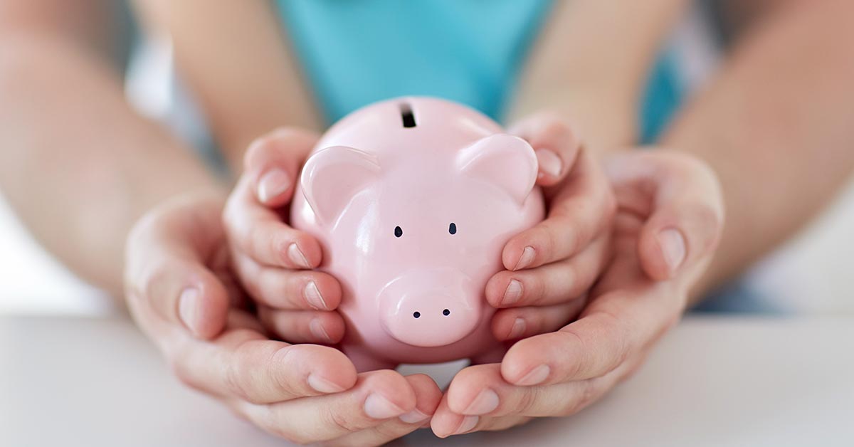 Hands holding a piggy bank, representing a family savings scheme